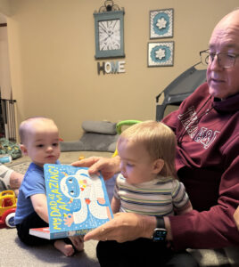 A photo of Jim Cline reading to his grandkids.