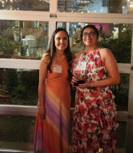 Lisa Minjares-Kyle, right, holding the award.