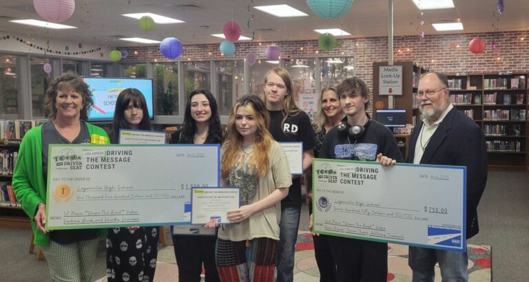 Loganville High School students accept a $1,500 award for their winning entry, “The Road is Ours.”