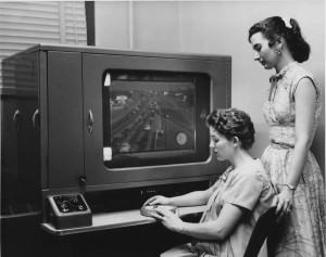 Historical photo of two ladies monitoring traffic through video.
