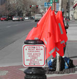 Highly visible orange flags are made available for pedestrians at a crosswalk in Salt Lake City, Utah.