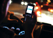 driver texting while driving at night