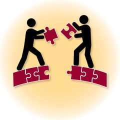 drawing of two stick figures putting puzzle pieces together; symbolizing teamwork