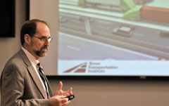 Steve Roop discussing the Freight Shuttle System during a presentation.