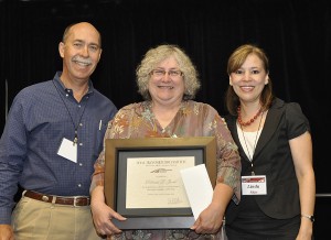This is a photo of Debbie Jasek accepting a Diversity Service Award at TTI Day.