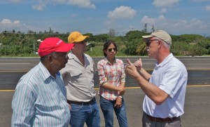 A photo of Tom Scullion explaining highway maintenance to representatives from the Domincan Republic.