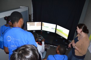 This is a photo of Houston Works USA students trying their skills on the TTI driving simulator.