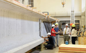 John Mander (center, white hard hat) , Mary Beth Hueste (far right) with graduate student researchers in the High Bay Structural and Materials Testing Laboratory.