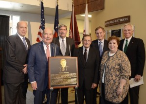 Guests at the Herb Richardson Texas Transportation Hall of Honor standing beside the plaque.