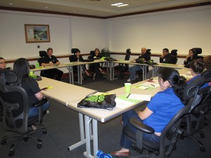 Group of people sitting at tables during a meeting.