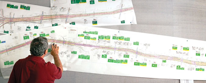 person looking at a map of roadway with traffic signs identified along the length