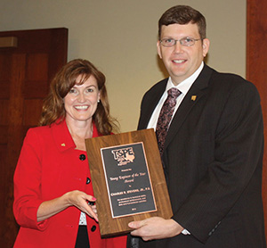 Charlie Stevens receives the Young Engineer of the Year award from TSPE President Trish Hatley.