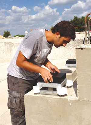 Tevfik Terzioglu installing load cells and bearing pads for the bridge during testing.