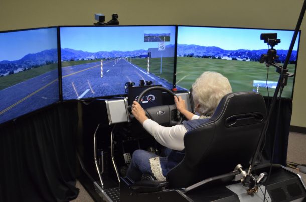 A volunteer driver using a driving simulator for a distracted driving study.
