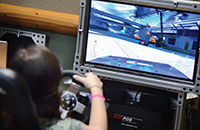 TDS Summit participant tries out one of the driving simulators